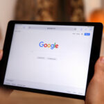 Business owner searching for digital marketing services on smartphone in Gainesville FL