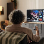 Family watching streaming TV ads on connected TV in modern living room