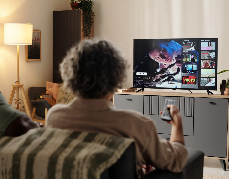 Family watching streaming TV ads on connected TV in modern living room
